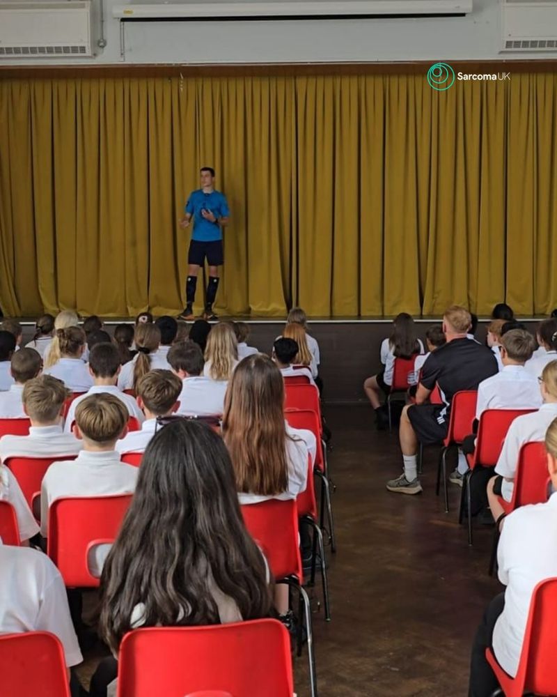 Sean delivering an assembly to students