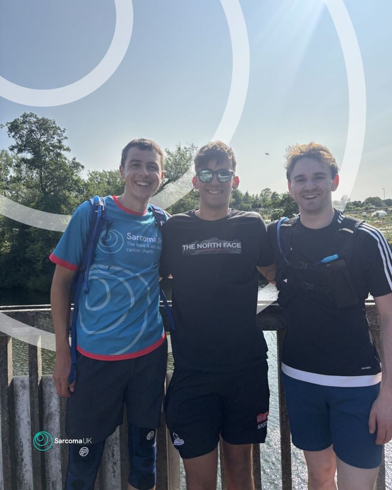Photo of Sean in his Sarcoma UK top and two friends.
