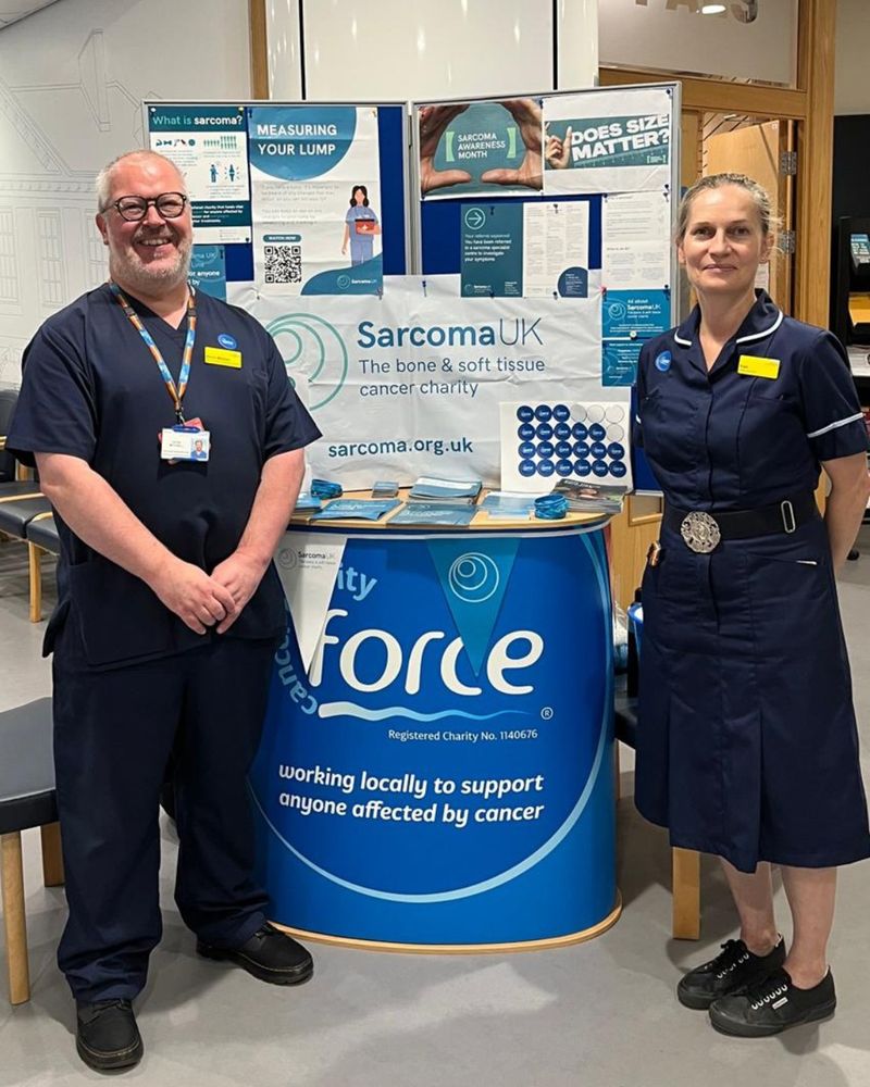 Photo of two members of the Devon team with their awareness stand.