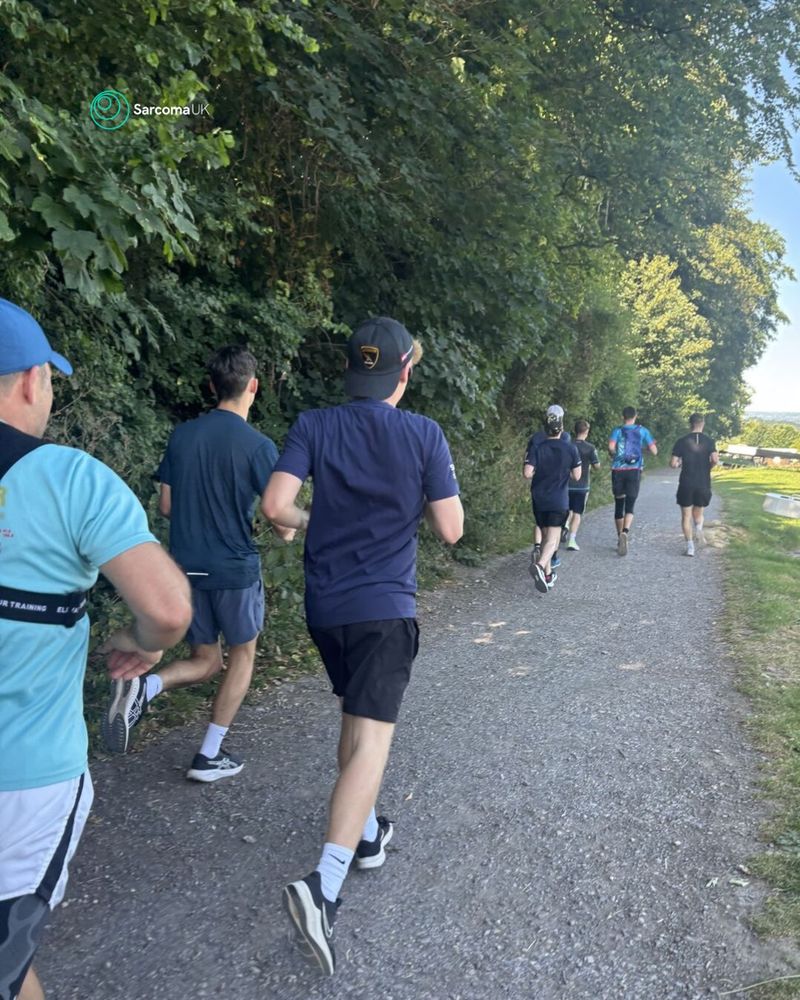 Sean and friends running along a path, away from the camera.