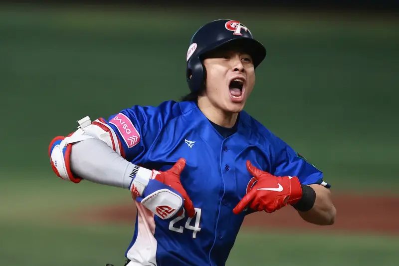 Taiwan baseball national team captain Chen Chieh-hsien the non-existent TAIWAN Logo on th his jersey with both hands in front of his chest.