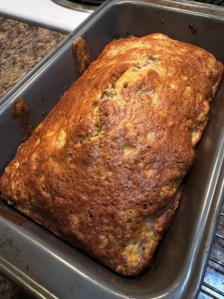 a freshly baked loaf of dark gold banana bread 