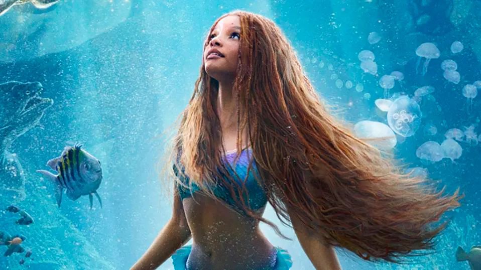 Ariel is a mermaid with dark skin and red braids.
