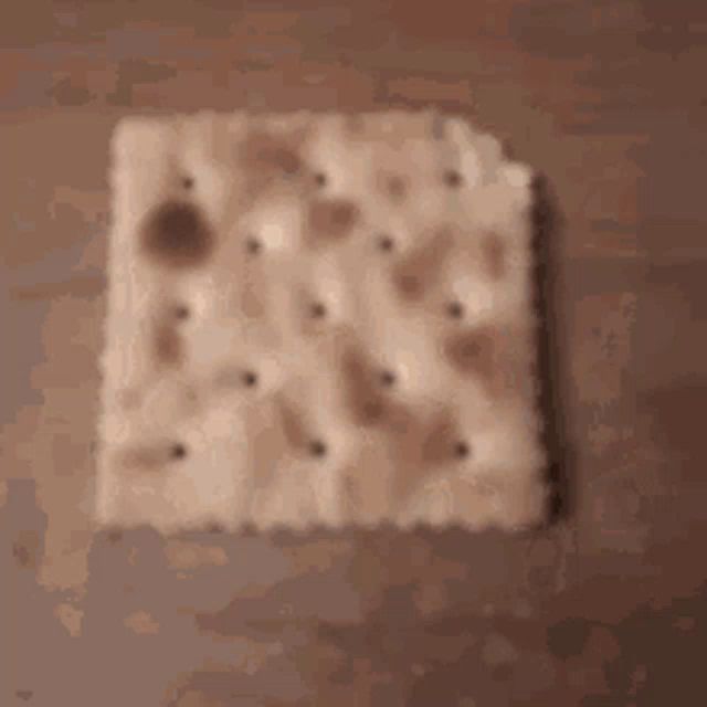 a close up of a cracker with holes in it .