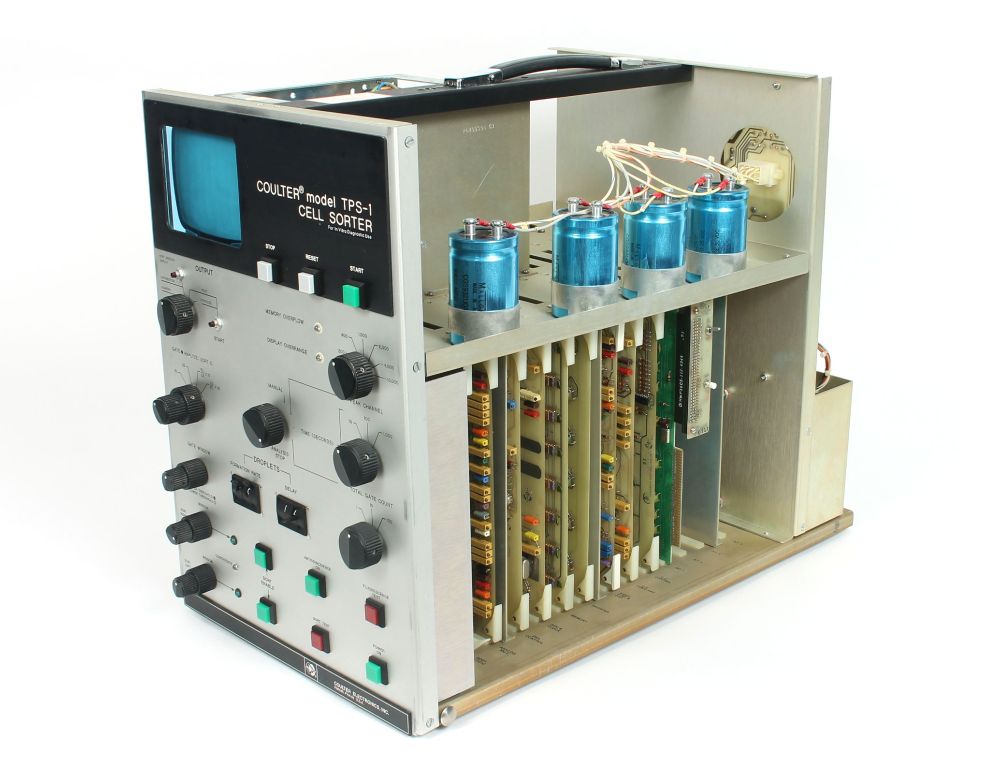 The analyzer element of a Coulter Cell Sorter with its lid off, revealing the electronic components inside.