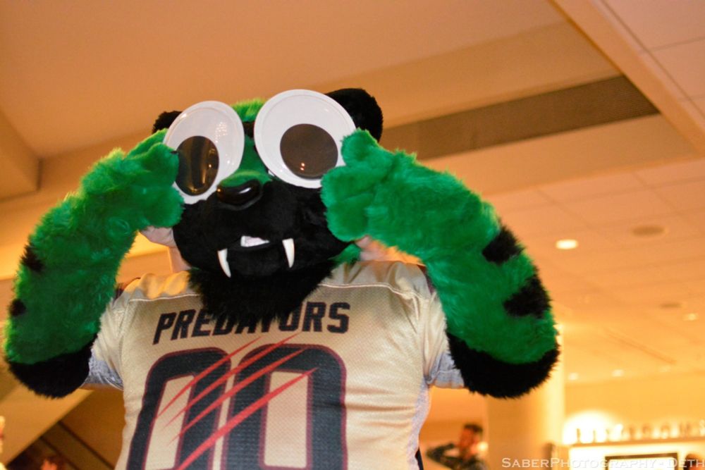 Slash in suit with the predators jersey holding giant googly eyes to his face