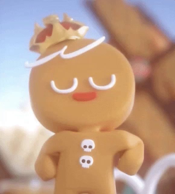 a gingerbread man with a crown on his head is standing in front of a pile of gingerbread cookies .