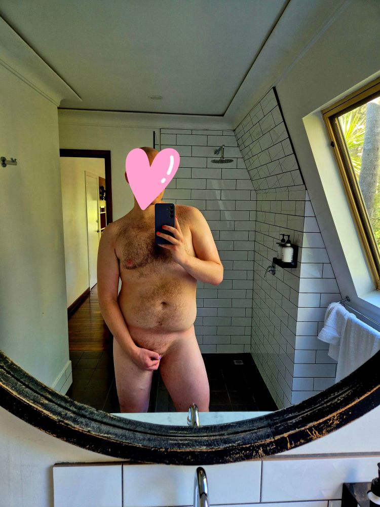 Man poses for mirror selfie post-shower 