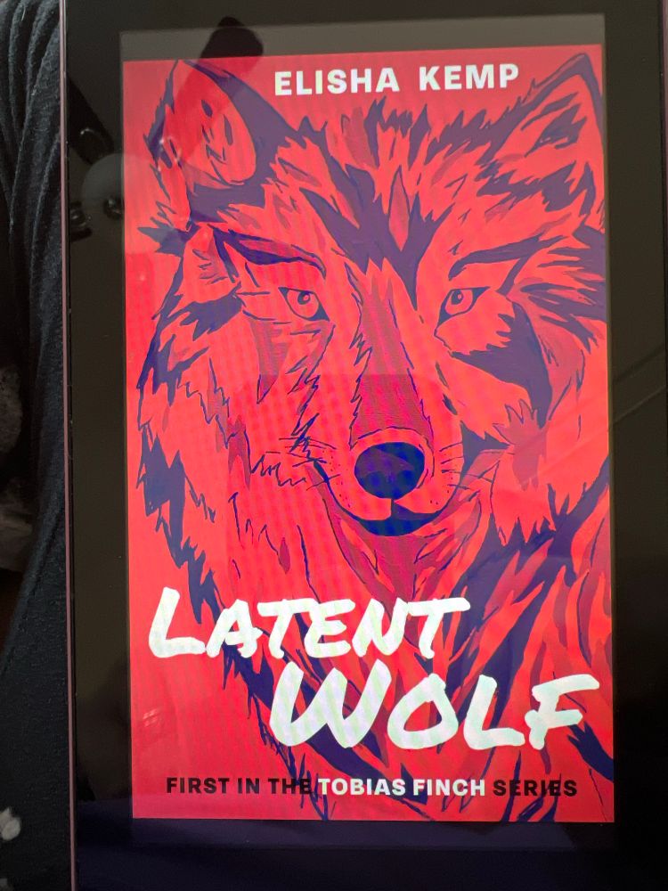 A drawing of a wolf face on a red book cover