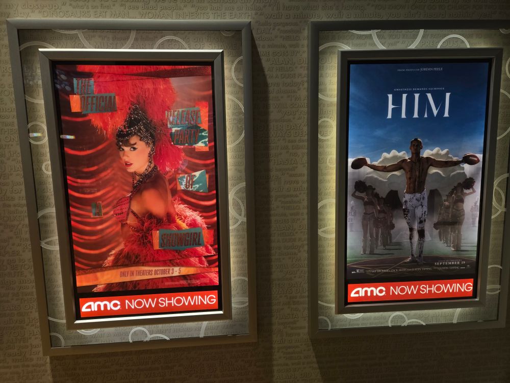 the life of a showgirl poster hung up next to poster for HIM, the football horror film.