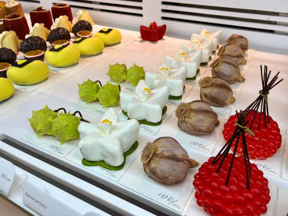 A case of pastries in highly realistic fruit and floral shapes at Honey in Kyiv