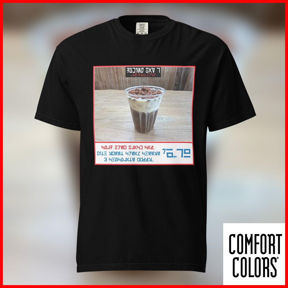 a black t-shirt with a design inspired from the Costco Food Court menu. Featuring a Docking Bay 7 classic Black Caf Cold Brew. This shirt design features a photo of the Black Caf with its creamy cheese topping along with Chocolate cereal puffs. Under the photo is some Aurebesh describing the menu item along with its price.