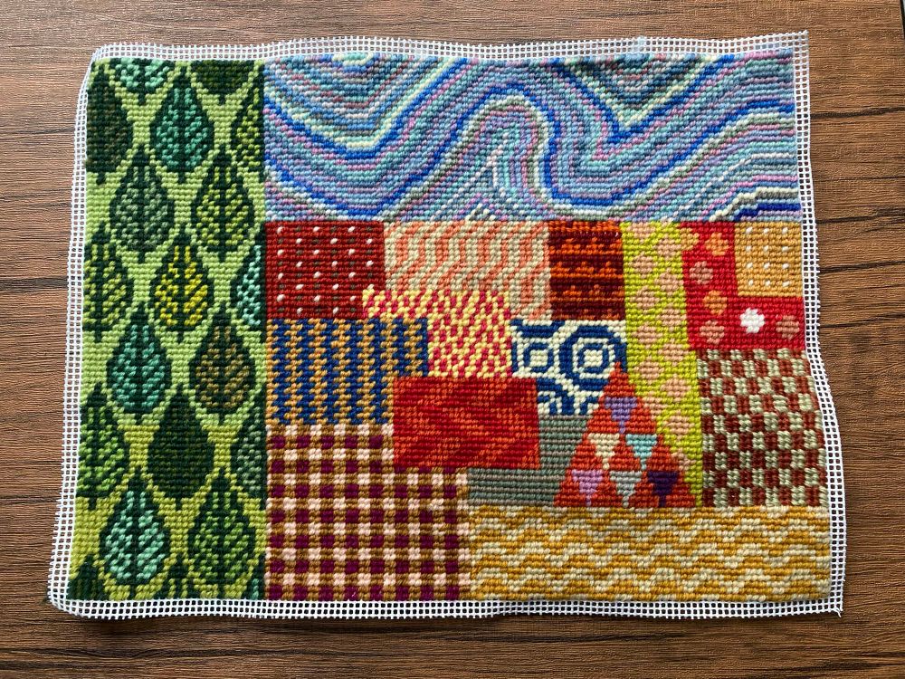 Improvised tapestry with green leaf panel, blue swirly panel and red and yellow geometric panel