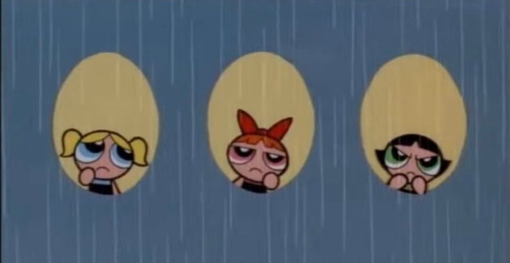The 3 Powerpuff girls looking out of a plane type window each at the grey rain outside and looking fed up and annoyed at it.