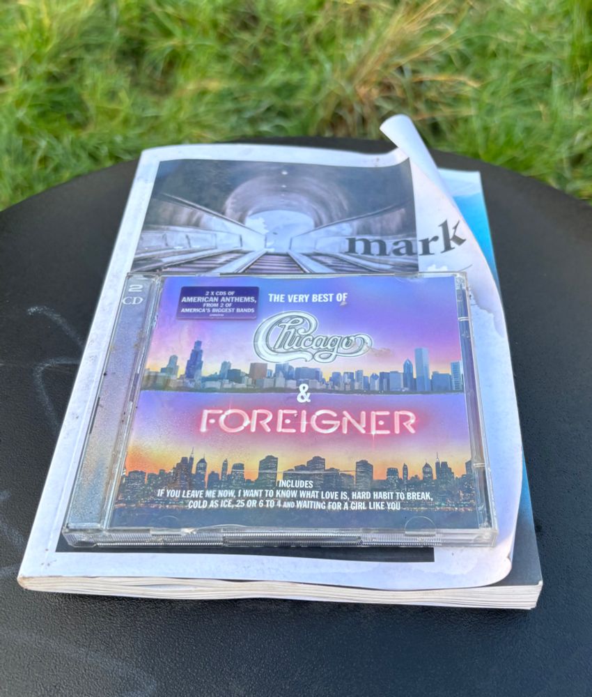 Chicago & Foreigner best of cd on top of a bin
