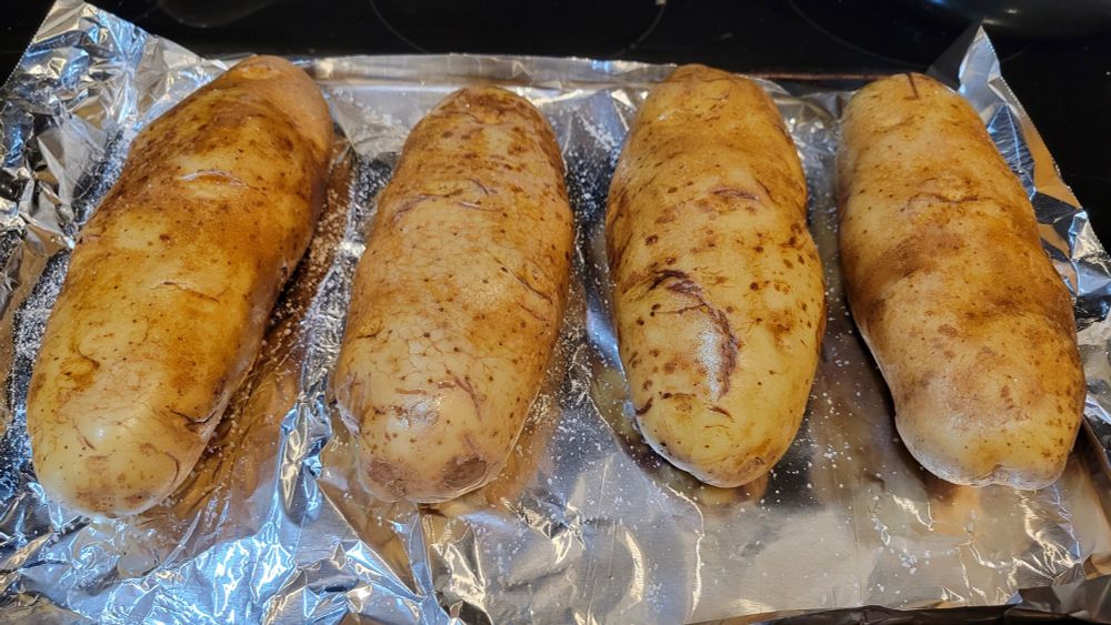 4 very large baking potatoes on a foil lined cookie sheet. 