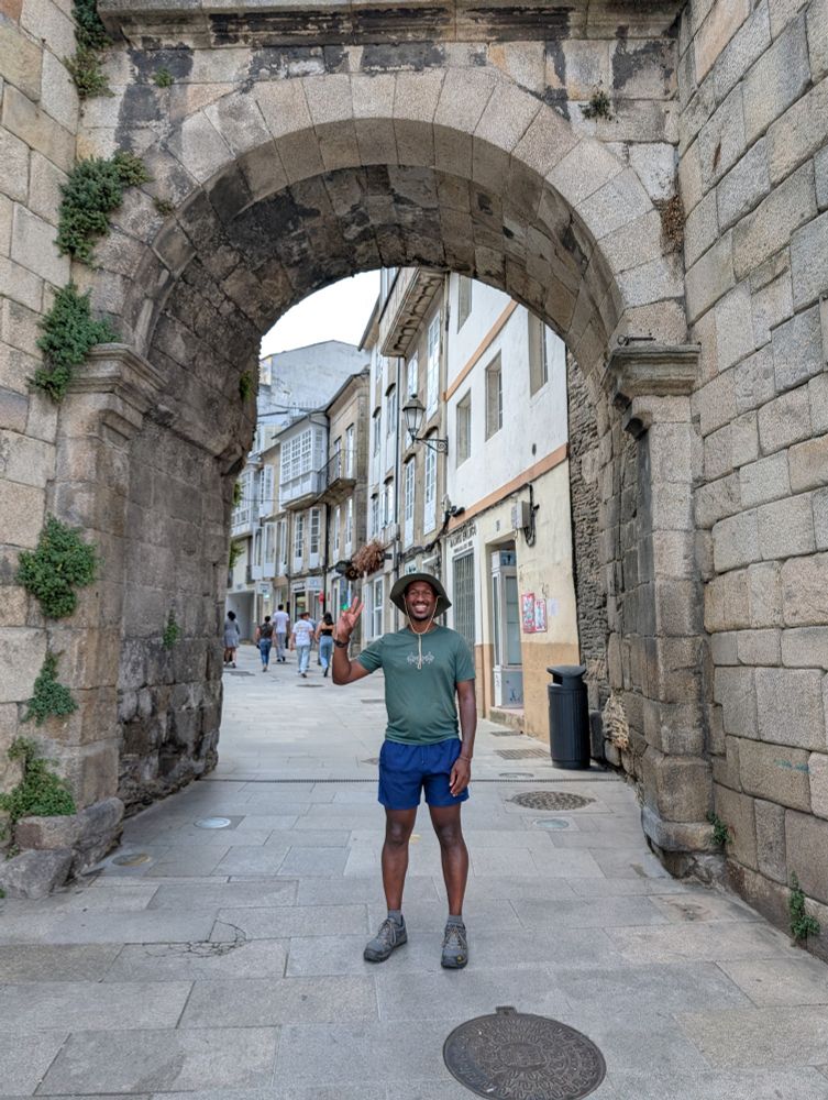 Me holding the peace sign ✌🏾 at the threshold of the Roman wall in Lugo