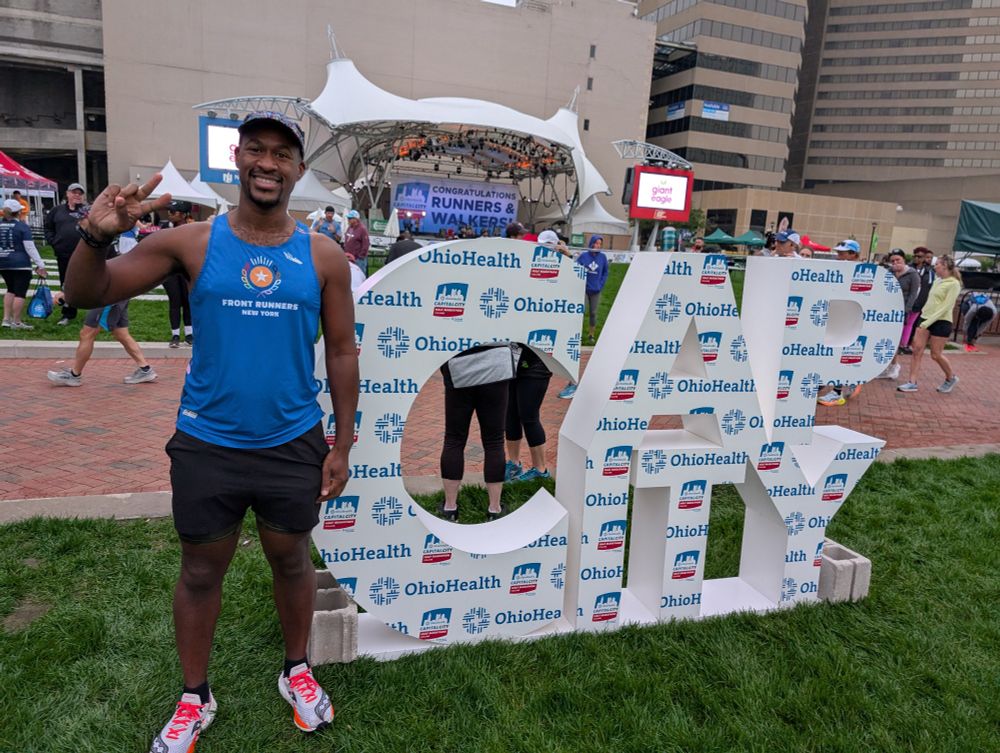 Me at the Cap City sign giving the peace sign ✌🏾