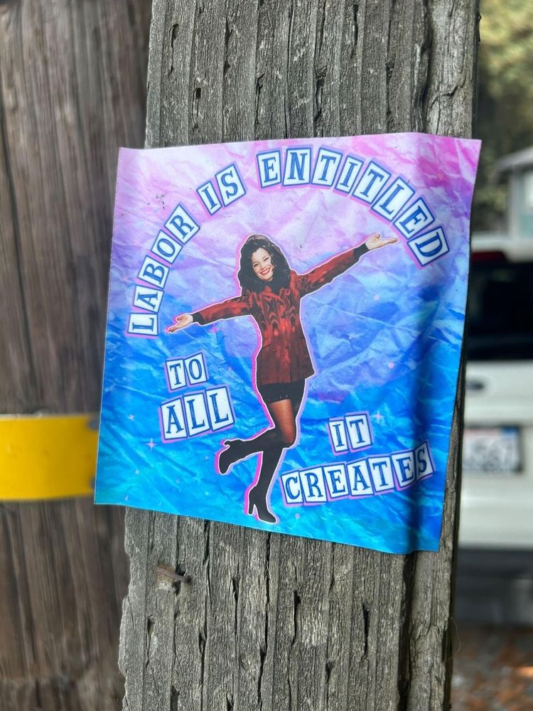 Sticker on wood featuring Fran Dresser as the Nanny and the words "Labor is entitled to all it creates"