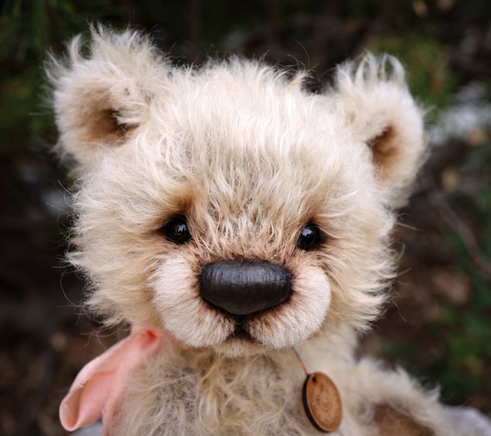 Teddy bear with sparse, soft mohair fur. Stitched nose sealed with beeswax then shaded with artist oil paints. She has glass eyes. 