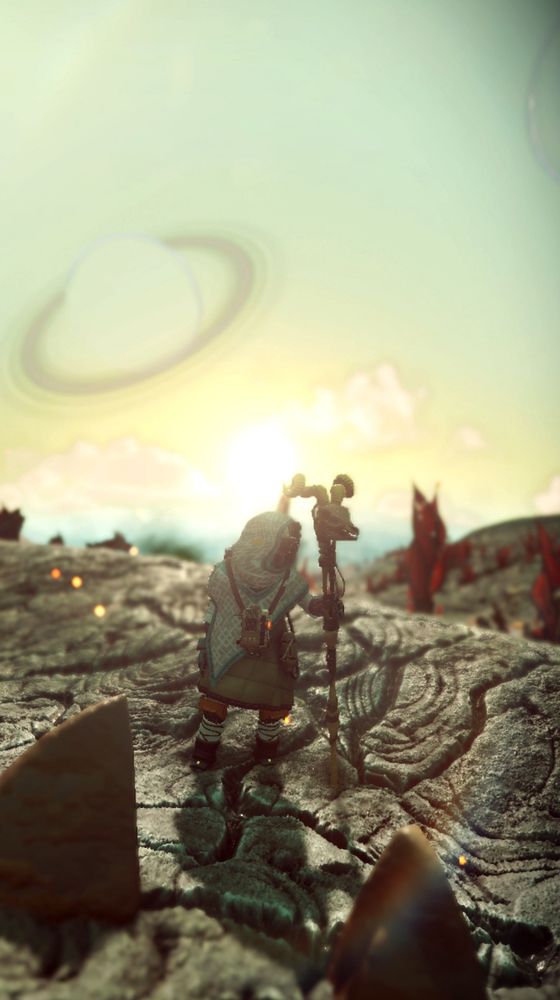 My player character (a gek autophage) standing in the middle of a desert. A ringed planet is behind and there's a glint of lens flare. They are a nerd.