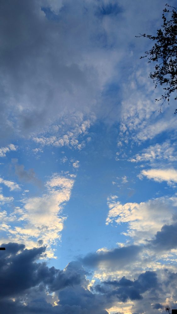 The same sunset and clouds, but the shadow is now much more stretched out across the whole photo.