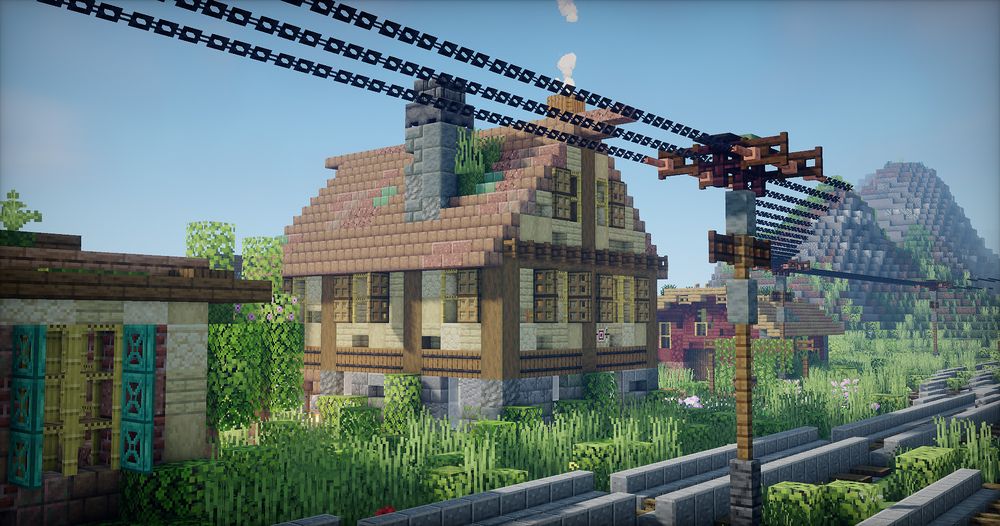 A minecraft screenshot of a three-story rustic house with two chimneys. In front of the house are Train Tracks and a Power line, with two Power poles visible. In the background is a farm shed and some hills/mountains.