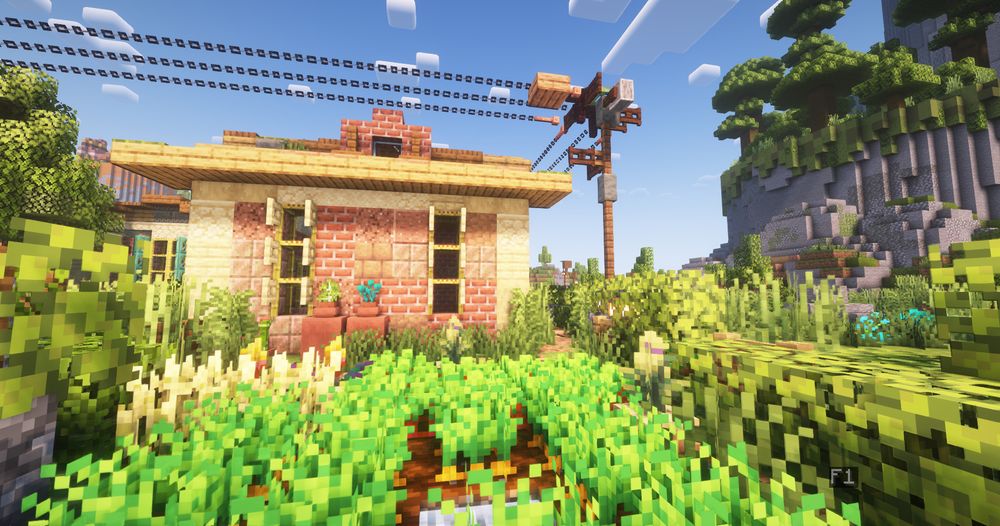 A Minecraft Screenshot with Shaders enabled, taken from a little garden with crops, showing a rustic House with a power line above it and a power pole on the right. In the background are trees, boulders and a cliff-like structure on the right with a jungle on top.