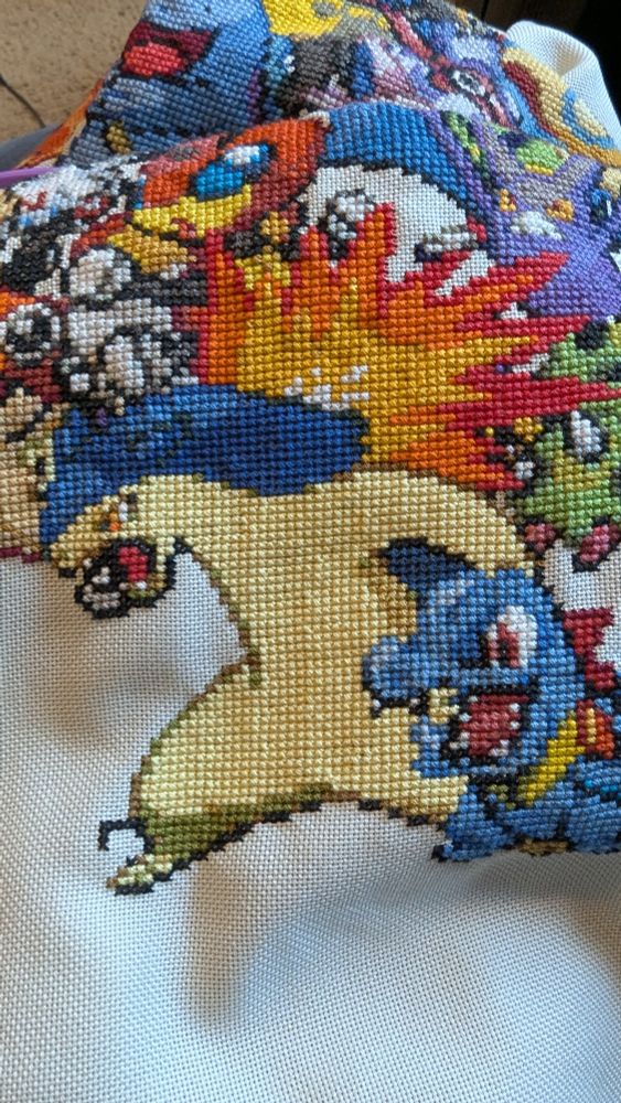 The Pokemon Typhlosion rendered in cross-stitch, among several other Pokemon