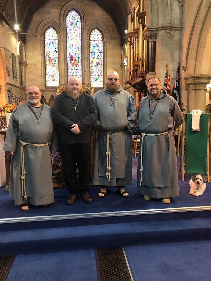 Four brothers, three in grey habits, one (Dave) in 'civvies,' wearing a tau cross as a sign of his postulancy