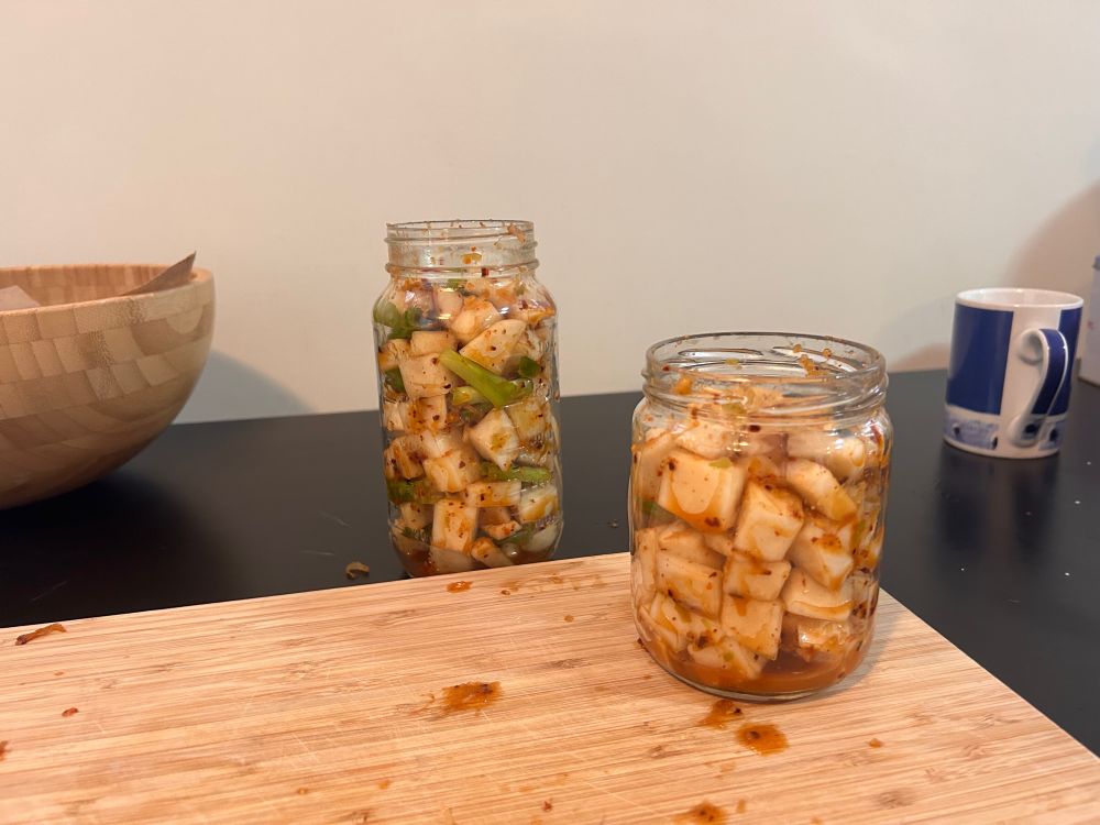 A jar of radish kimchi, and a jar of cabbage kimchi