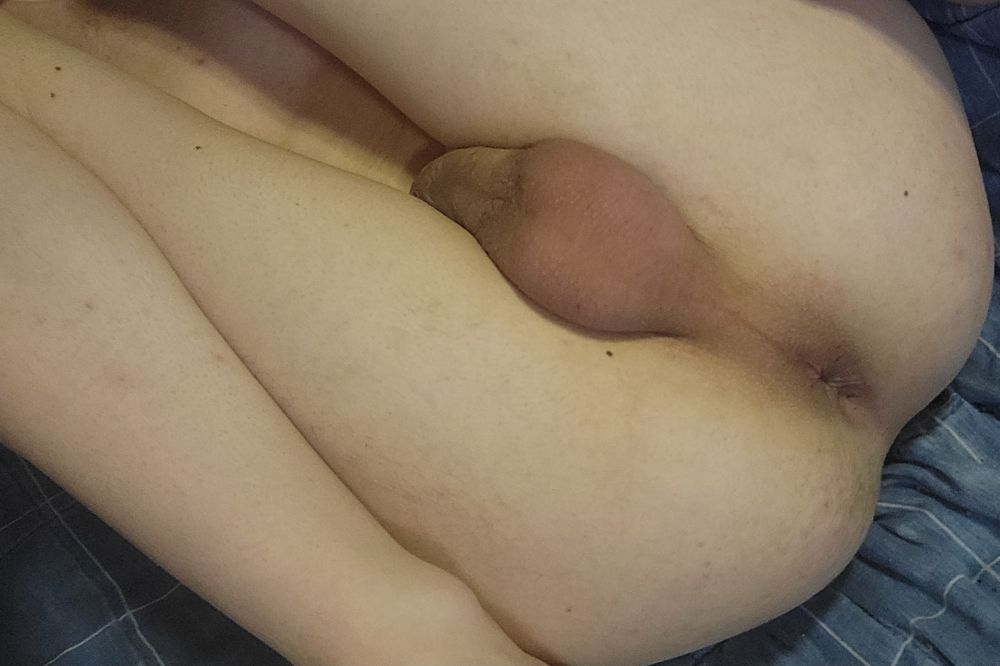 Me laying on my back with my lifted to my chest with my cock, balls, and hole being presented