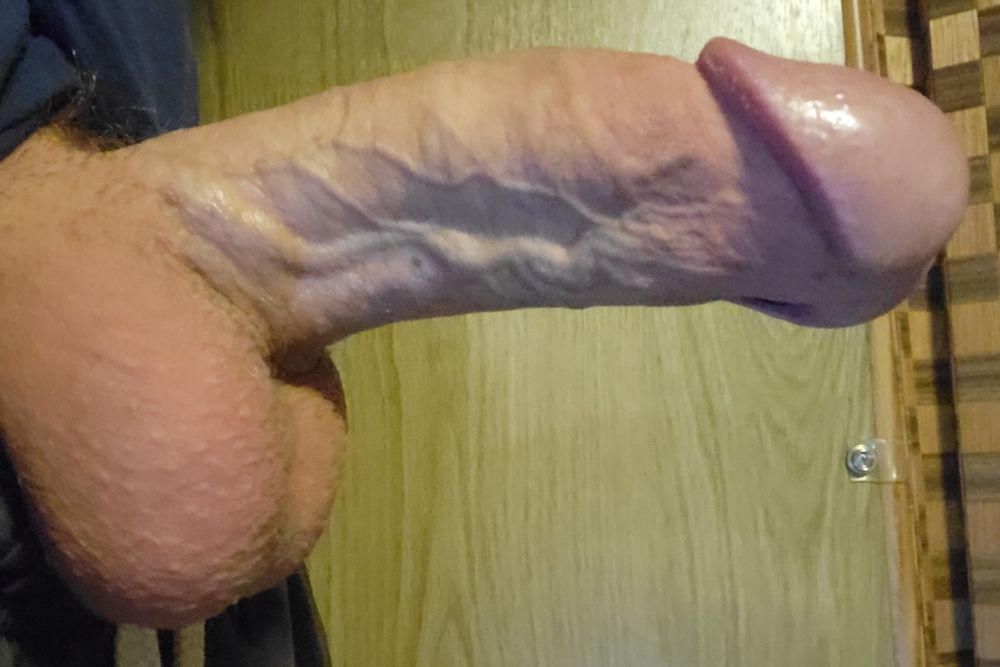 A close-up of my erect cock and balls peeking out of my briefs