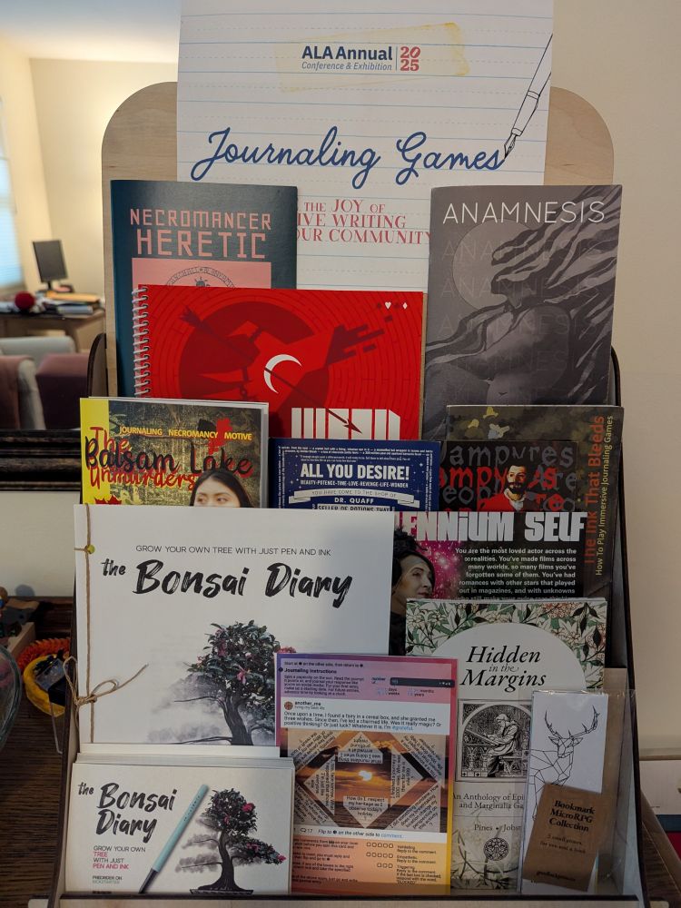 Zine rack showing many journaling and literary games