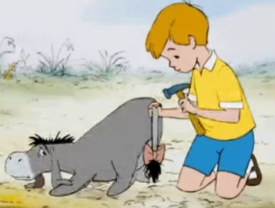 christopher robin reattaching eeyore's tail with a hammer and nail