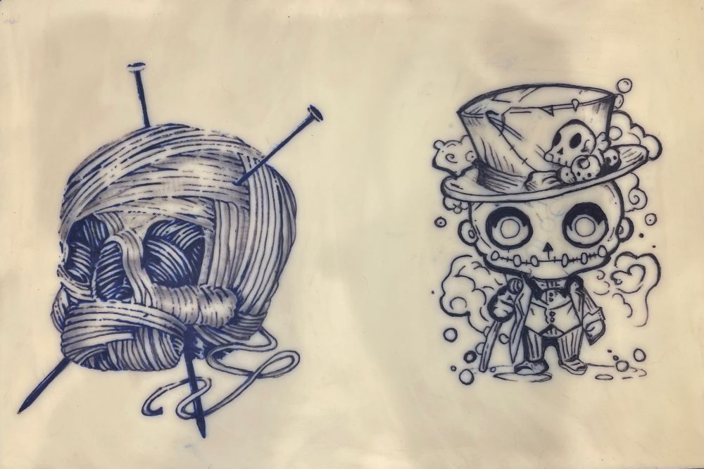 Practice tattoos of a yarn ball skull and a voodoo doll