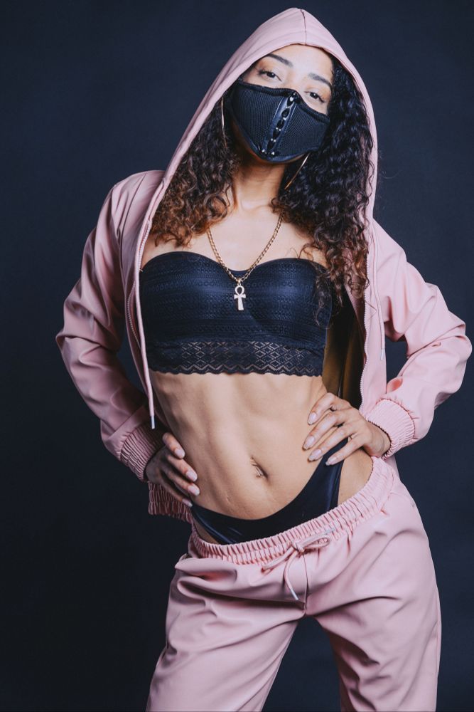 Woman wearing a facemask and pink tracksuit