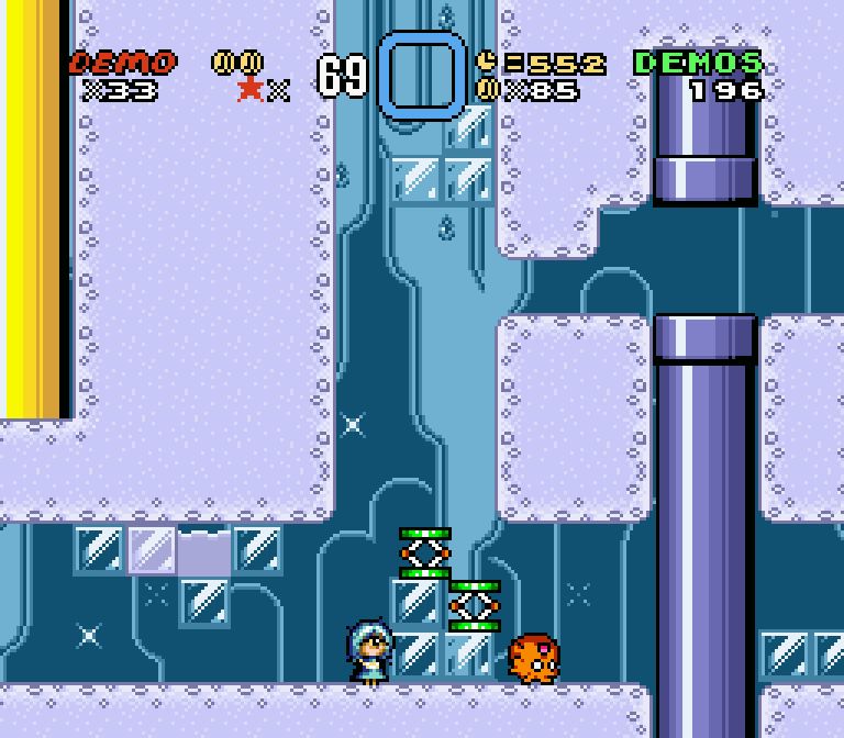a screenshot of A Super Mario Thing aka ASMT, a super mario world hack starring Demo, an armless cyclops. she stands in an ice level next to some ice blocks. there are two trampoline objects and also an orange fuzzball object which is supposed to be an FOE or "field observable enemy" from the game series Etrian Odyssey. you can't hear it but cirno's theme is playing in this stage and it's mad annoying in the SMW soundfont. the tweet text is a reference to an iosys video