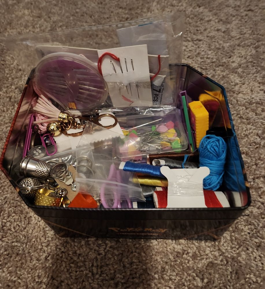 Instead of pokemon cards or pokemerch, i filled it with sewing stuff. Just like how moms and grandmas fill up those cookie tins with sewing stuff xD