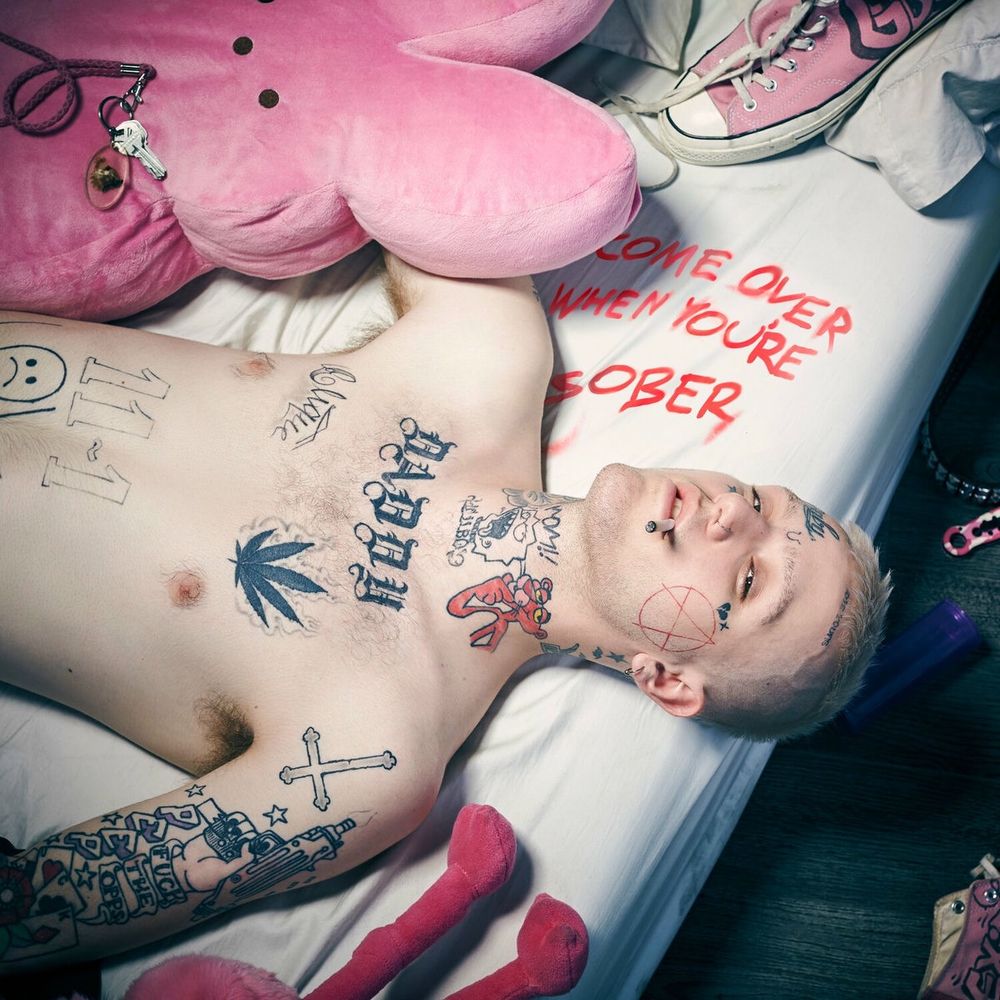Album cover for Lil Peeps " Come Over When You're Sober Pt. 1" depicting the artist lying shirtless on a bed, surrounded by pink colored plushies and accessories 