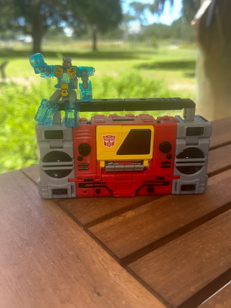 Blaster, in radio mode with his partner Eject sitting on top of him.
