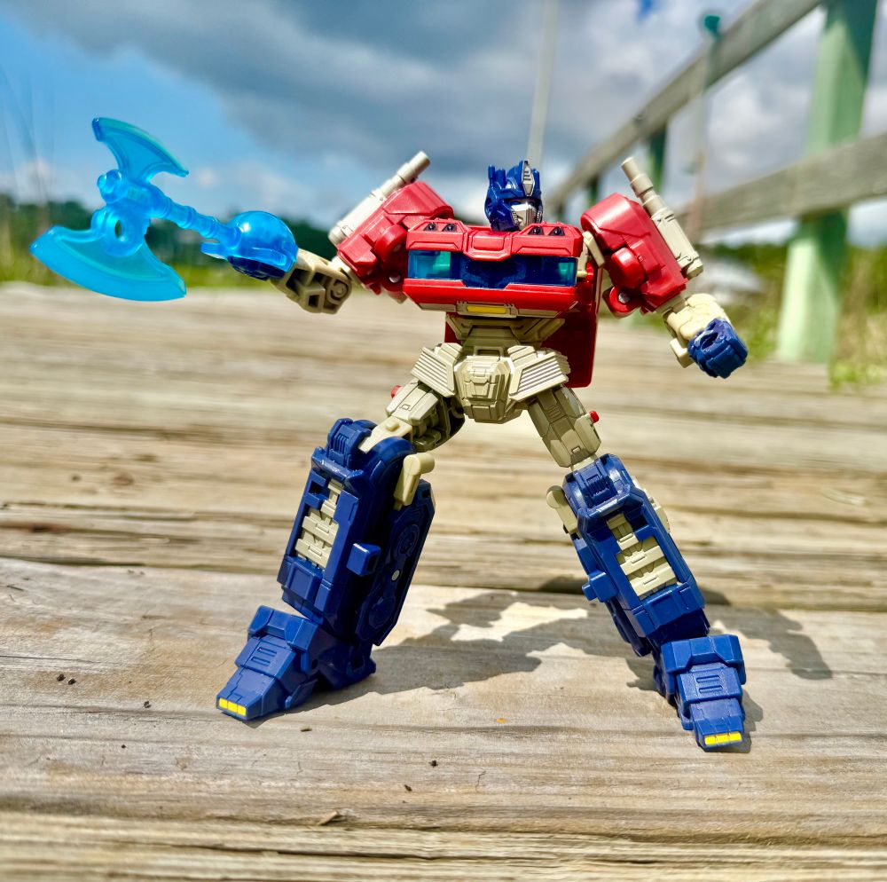 Studio Series Transformers One Optimus Prime standing in a defensive stance with his axe in hand.