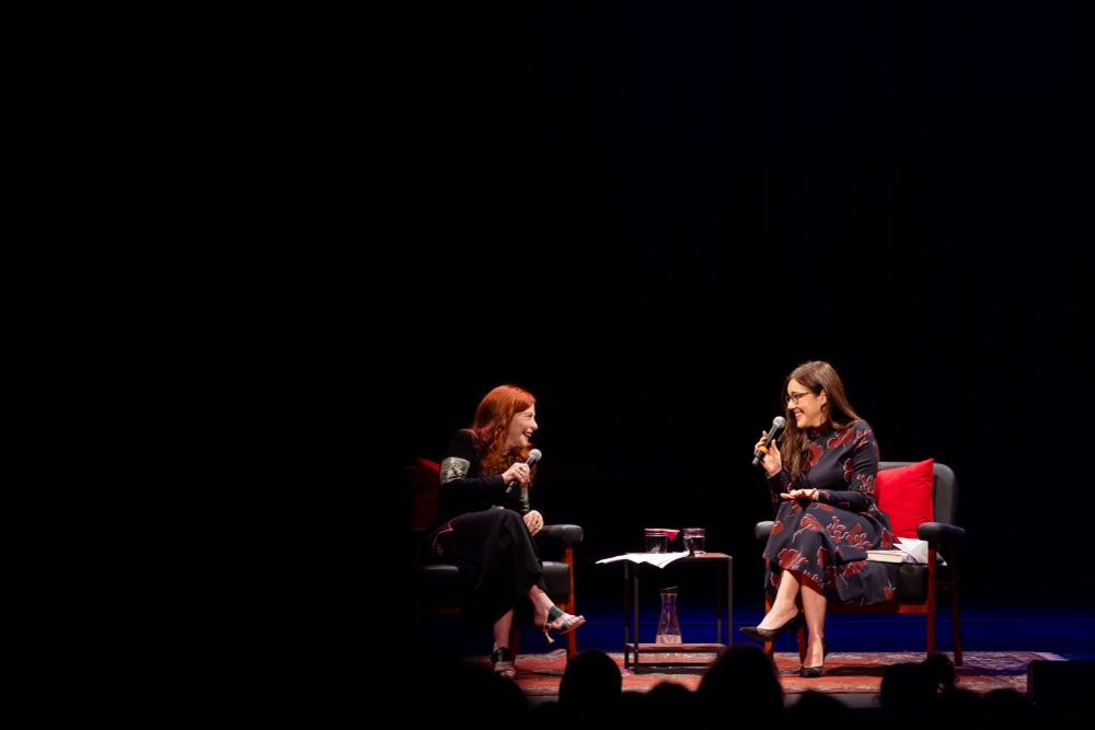 Susan Orlean and Sloane Crosley sit on the stage, holding microphones and having a conversation.