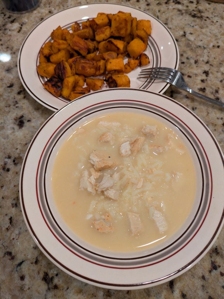 Lemon rice soup and baked sweet potato on a granite counter