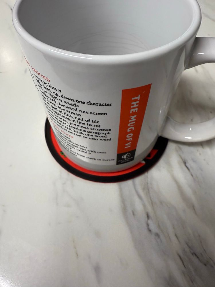 “Mug of Vi” from No Starch Press on the coaster.