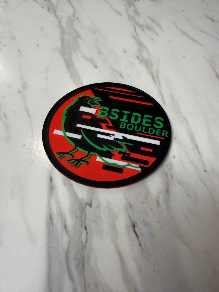 Coaster made with (a slightly off-color version of the) BSides Boulder 2025 logo.