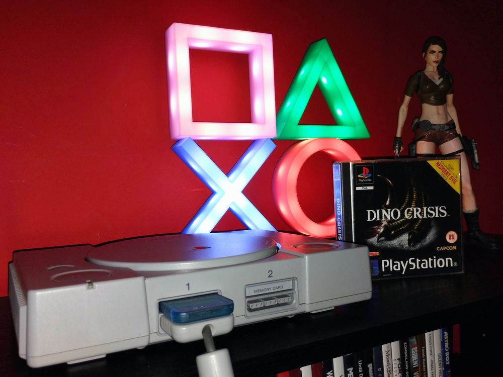 My PS1 with Dino Crisis, and my PlayStation light, accompanied by my Lara Croft Statue. 