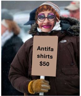 A friendly looking Soros employee holding a sign that reads "Antifa shirts $50". 