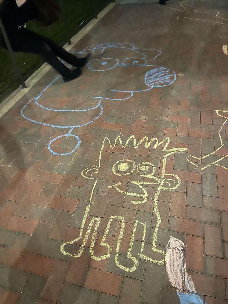 chalk portrait of brian griffin with homer simpson's combover. a rough looking tracy ullman-esque bart head crawls across the pavement on insect legs. im doing some kind of acrobatic maneuver on a guard rail to demonstrate the stretchiness of my pants (which ripped)