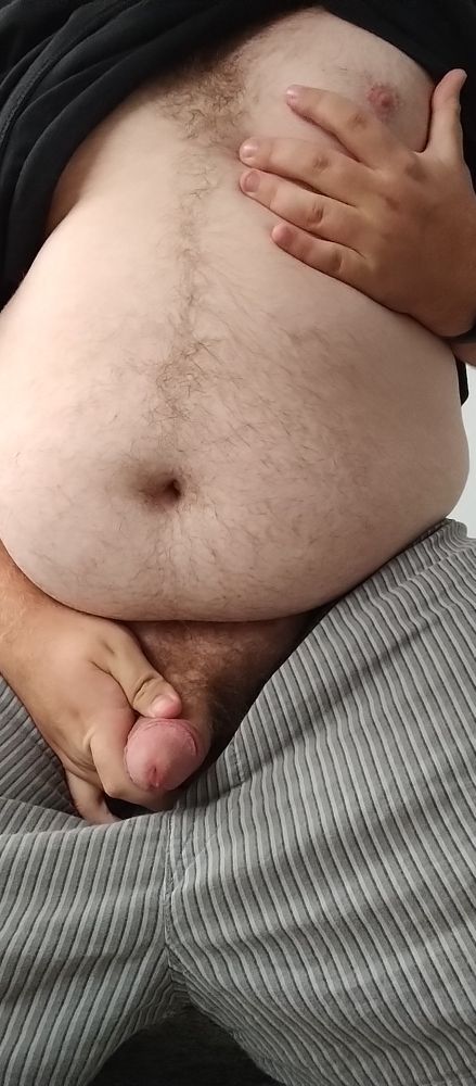 On my knees with my hands showing off my shaft and pecs.